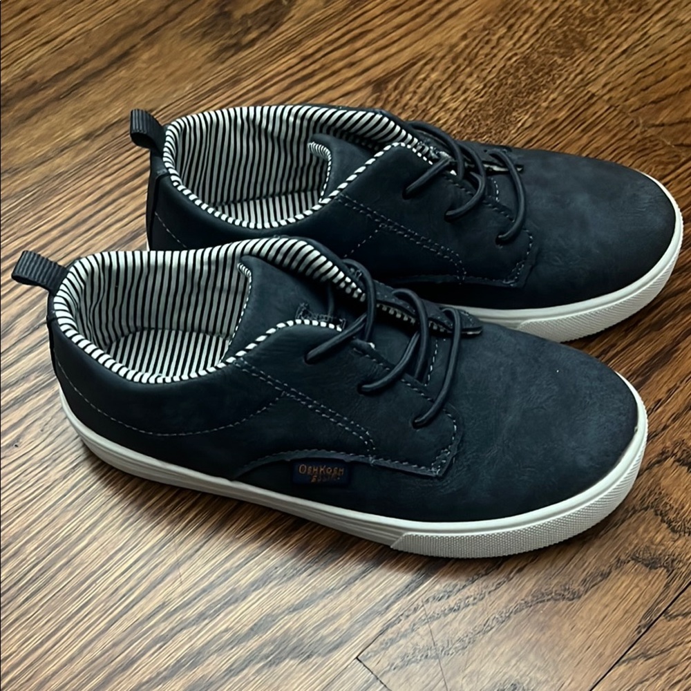 OshKosh navy/grey shoes with striped details.